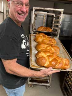 George Formaro holding tray of bread loaves