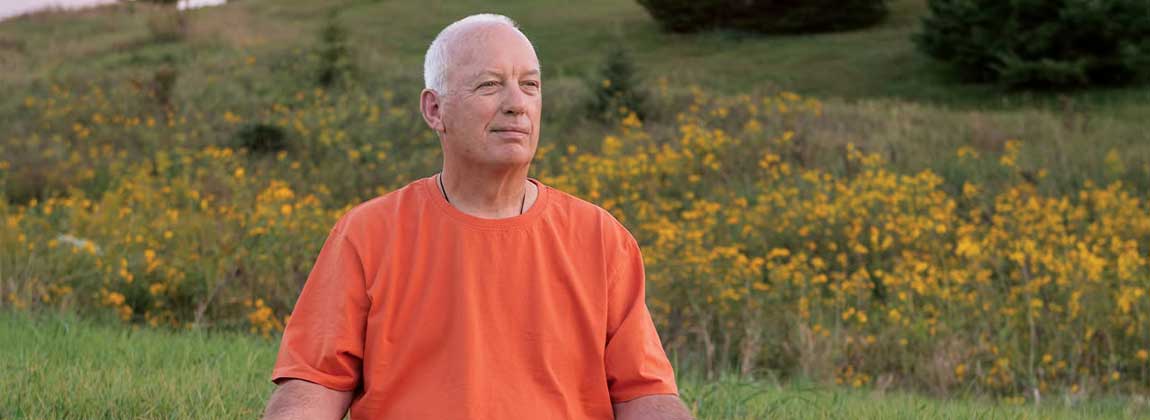 man doing outdoor yoga