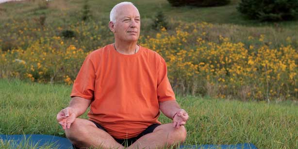 man doing outdoor yoga