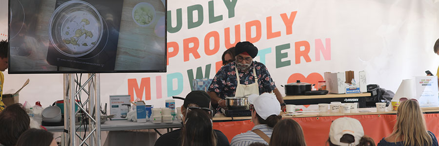 Culinary Discovery Pavilion A chef behind a table cooking in front of a crowd
