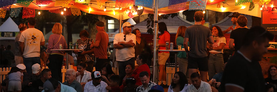 Festival Front Porch People under lights talking and enjoying drinks