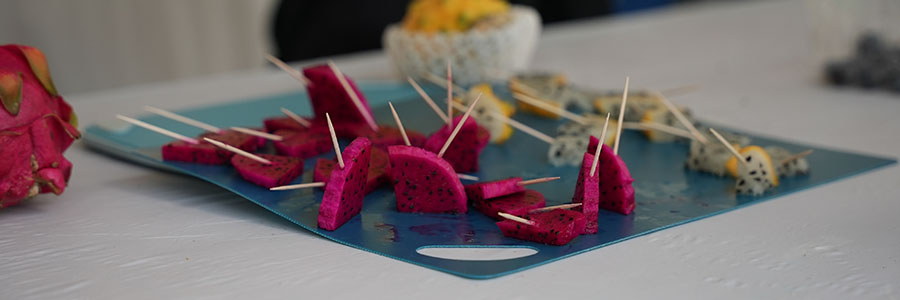 Fruit Adventure A cutting board with dragon fruit cut and toothpicks