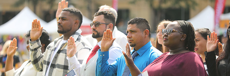 Naturalization Ceremony People in a line with their right hand up